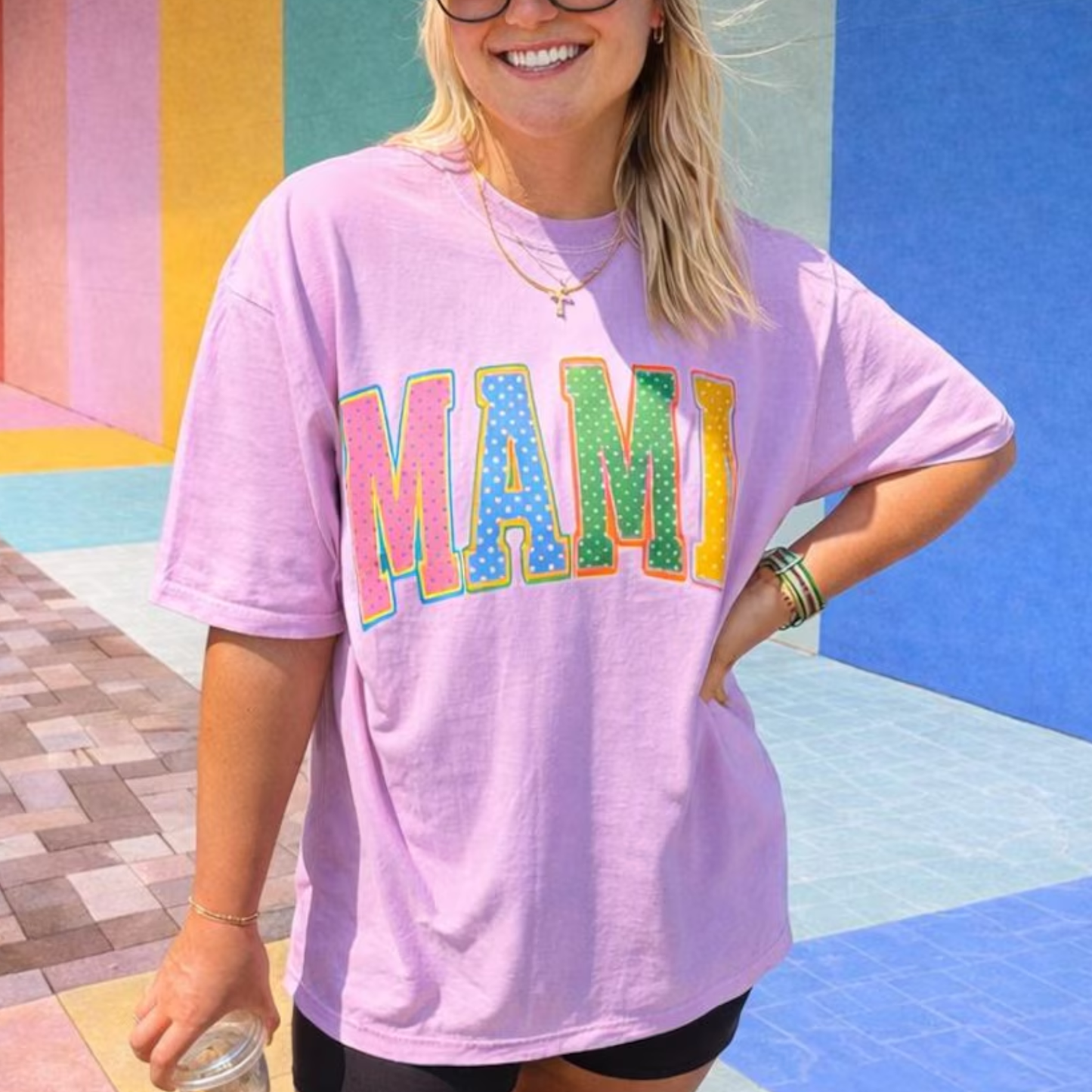 Woman wearing oversized orchid Comfort Colors mama graphic tee with colorful retro polka dot lettering