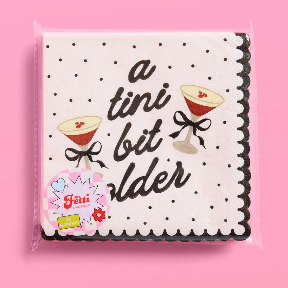 Pack of napkins with cocktail graphics and text on a pink background