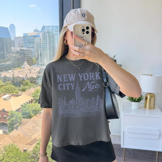 Woman wearing New York City graphic tee with vintage NYC skyline design