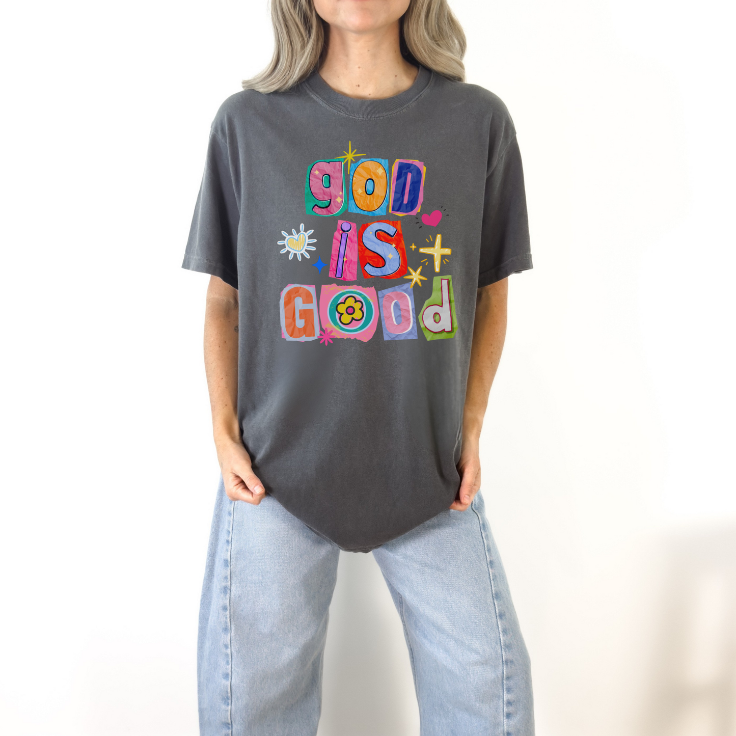 Woman wearing dark gray God Is Good colorful graphic tee styled casually