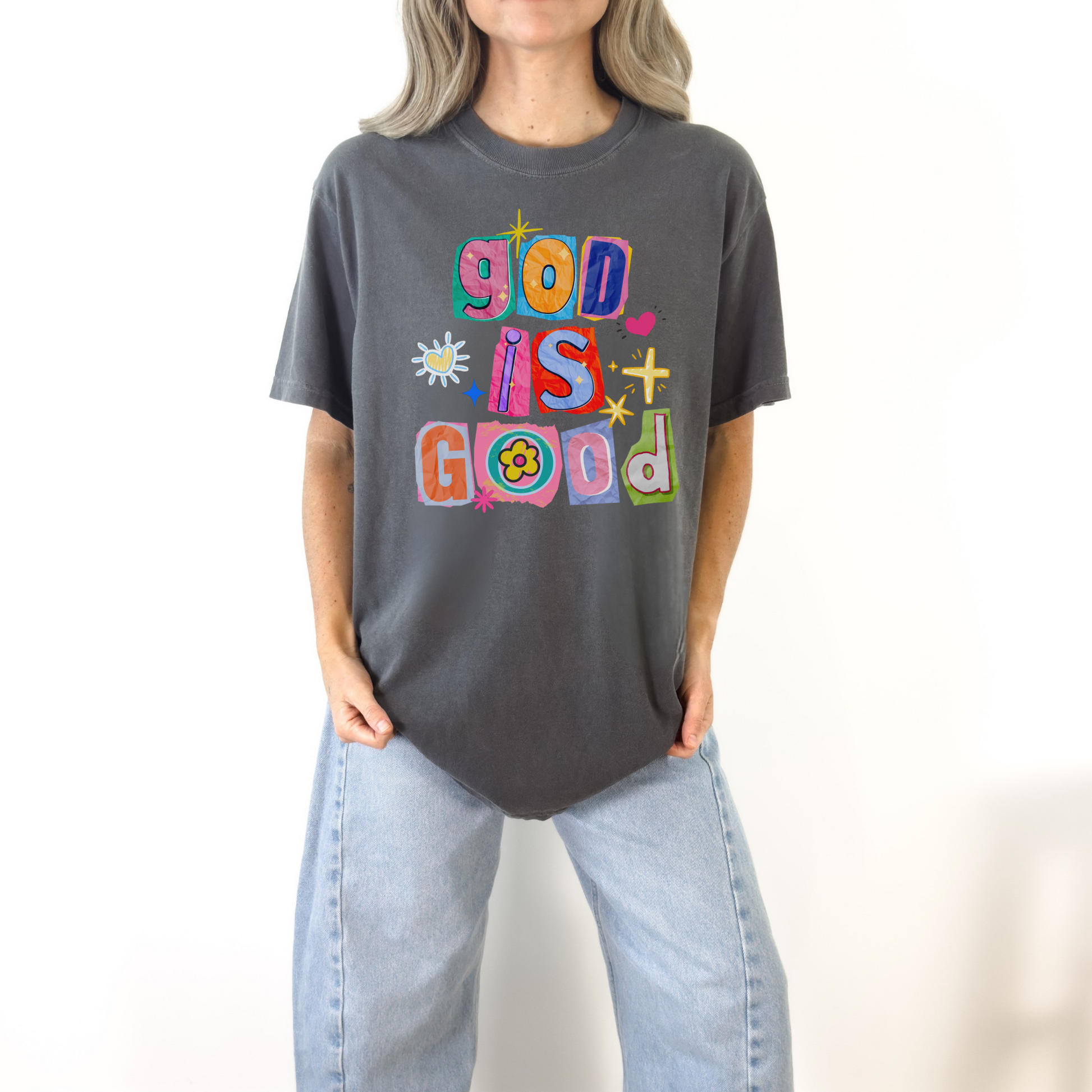 Woman wearing dark gray God Is Good colorful graphic tee styled casually