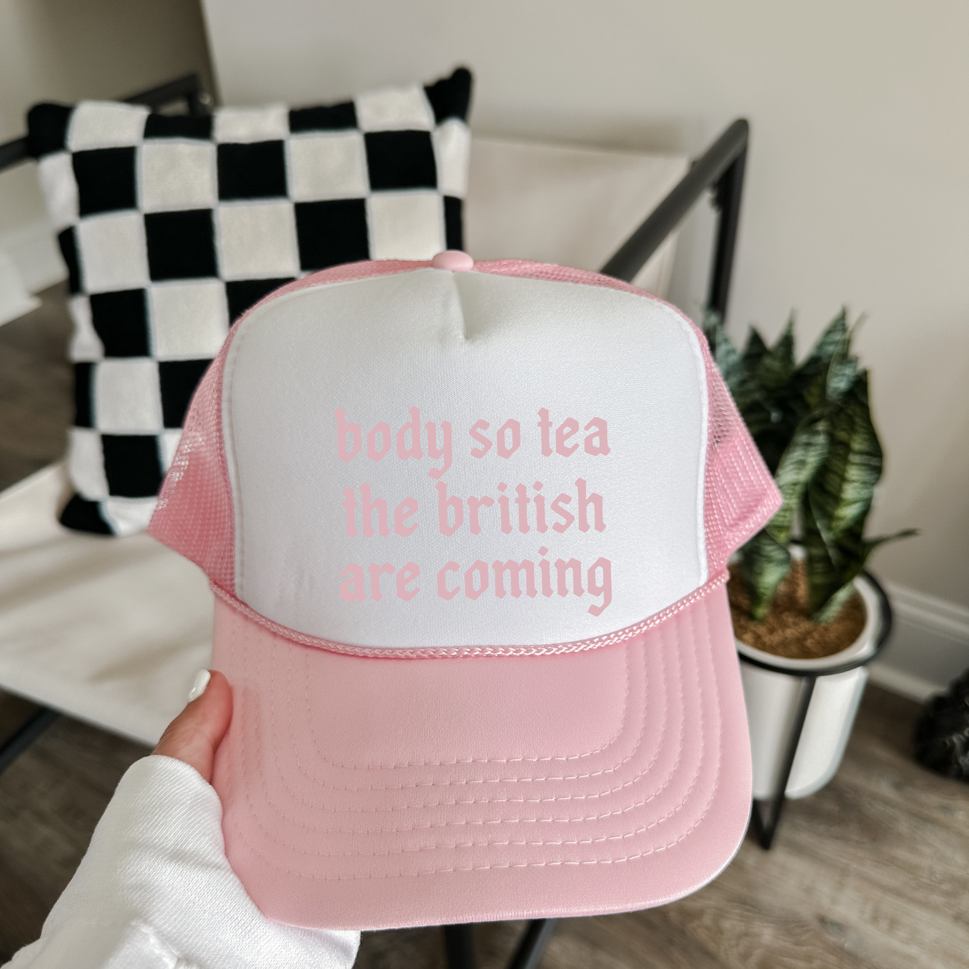 Pink and white trucker hat with viral funny saying text