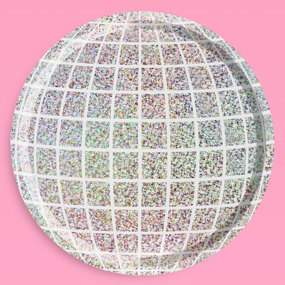 Round decorative plate with a grid pattern on a pink background