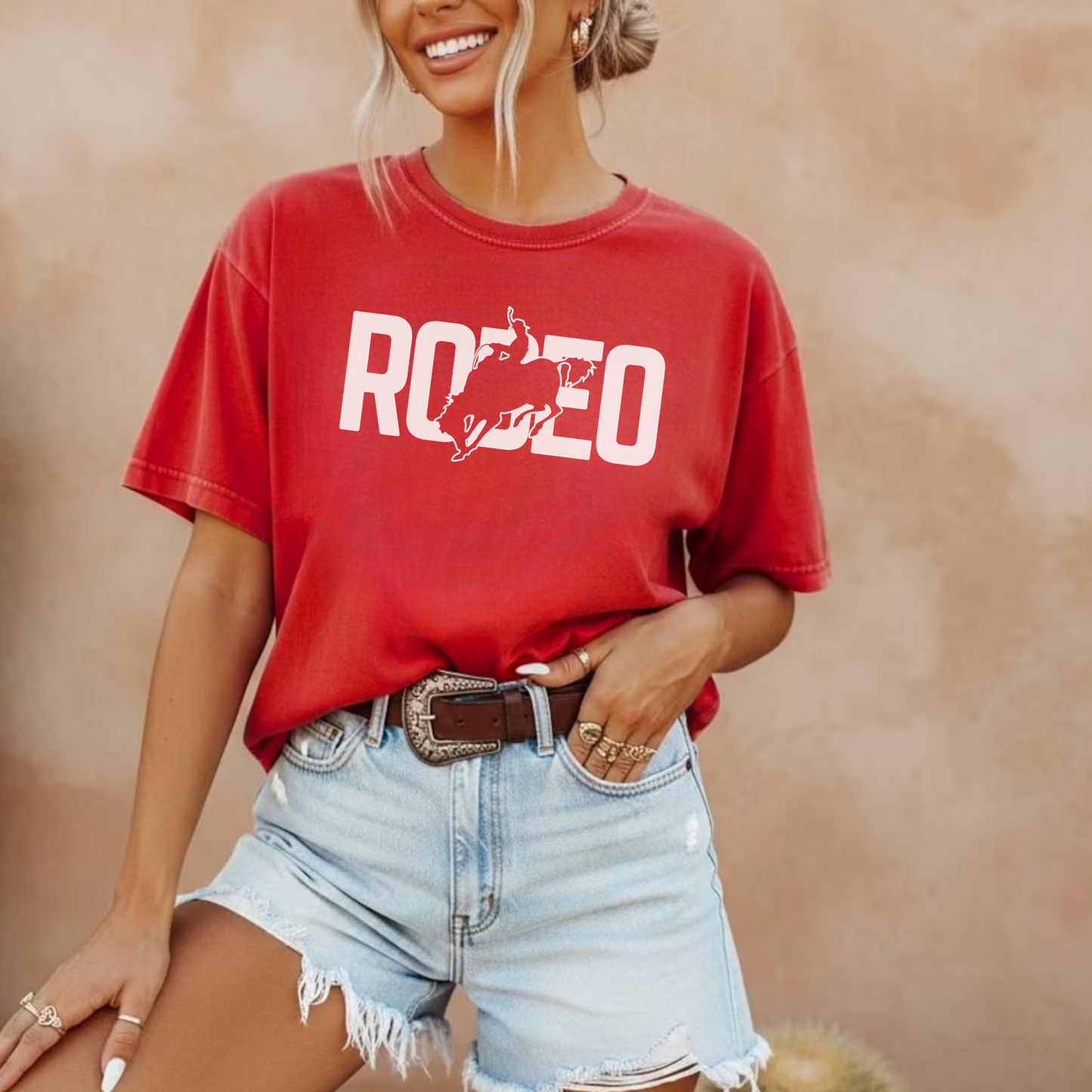 Red rodeo graphic t shirt styled with denim shorts and western accessories
