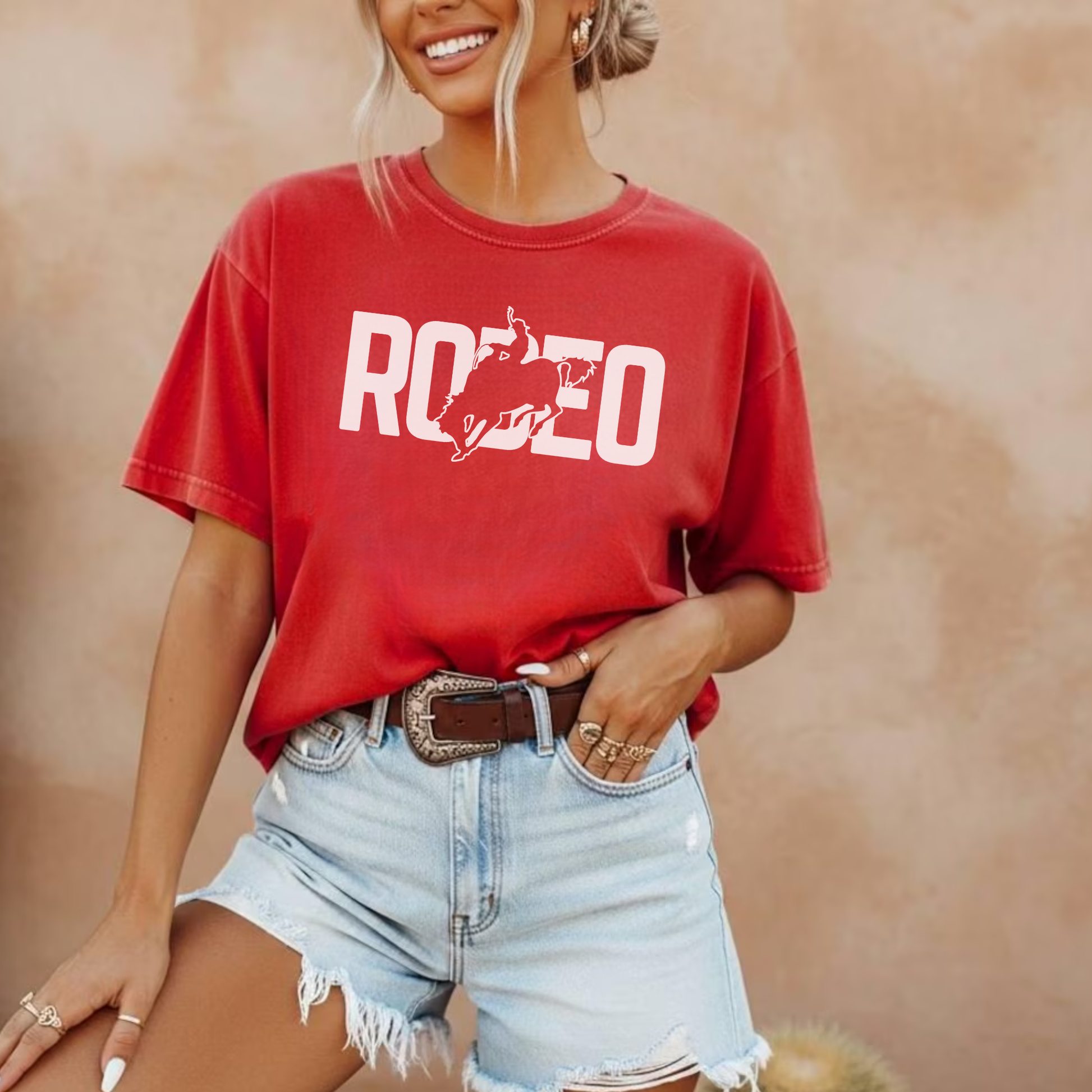 Red rodeo graphic t shirt styled with denim shorts and western accessories