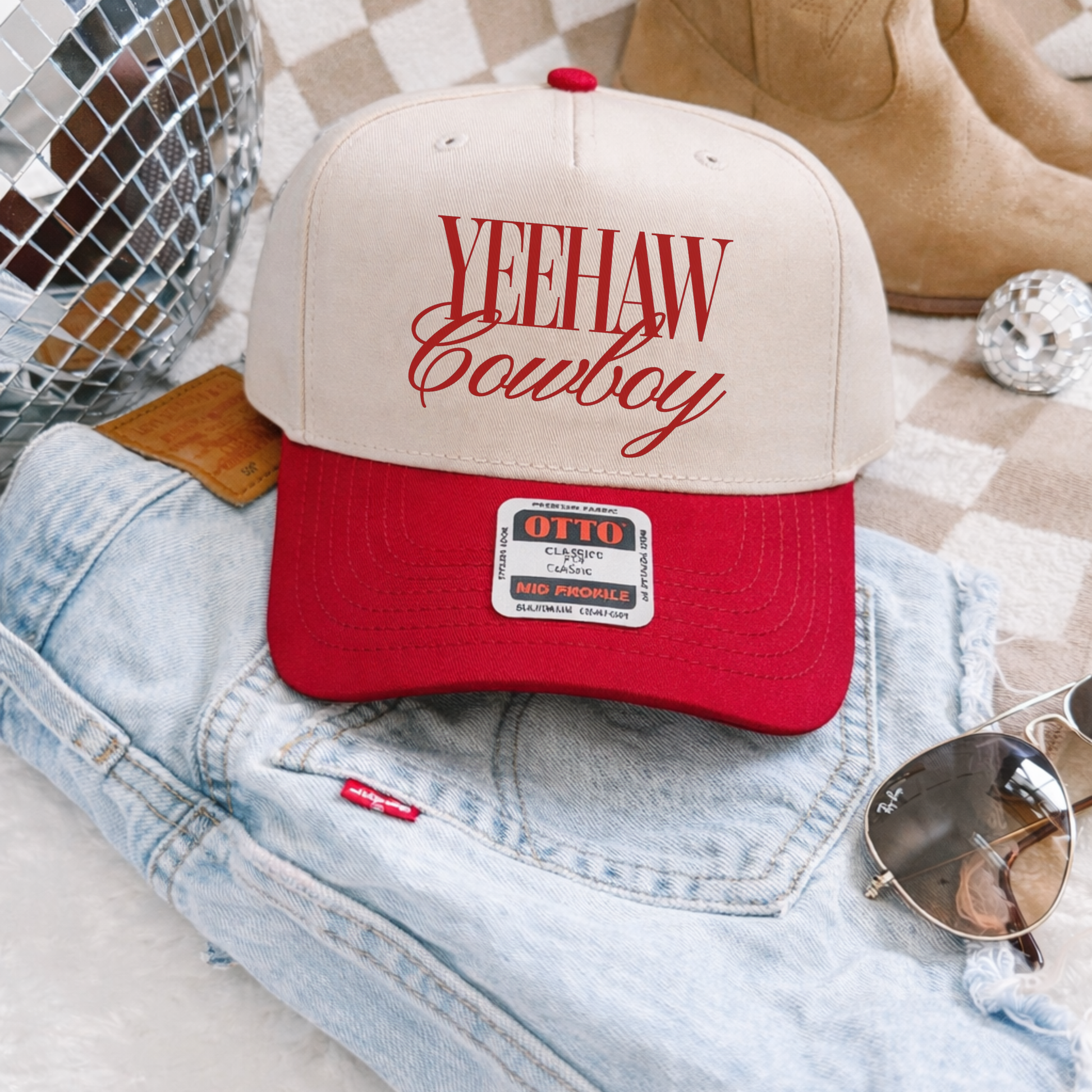 Yeehaw Cowboy red and canvas western trucker hat flat lay with denim and boots