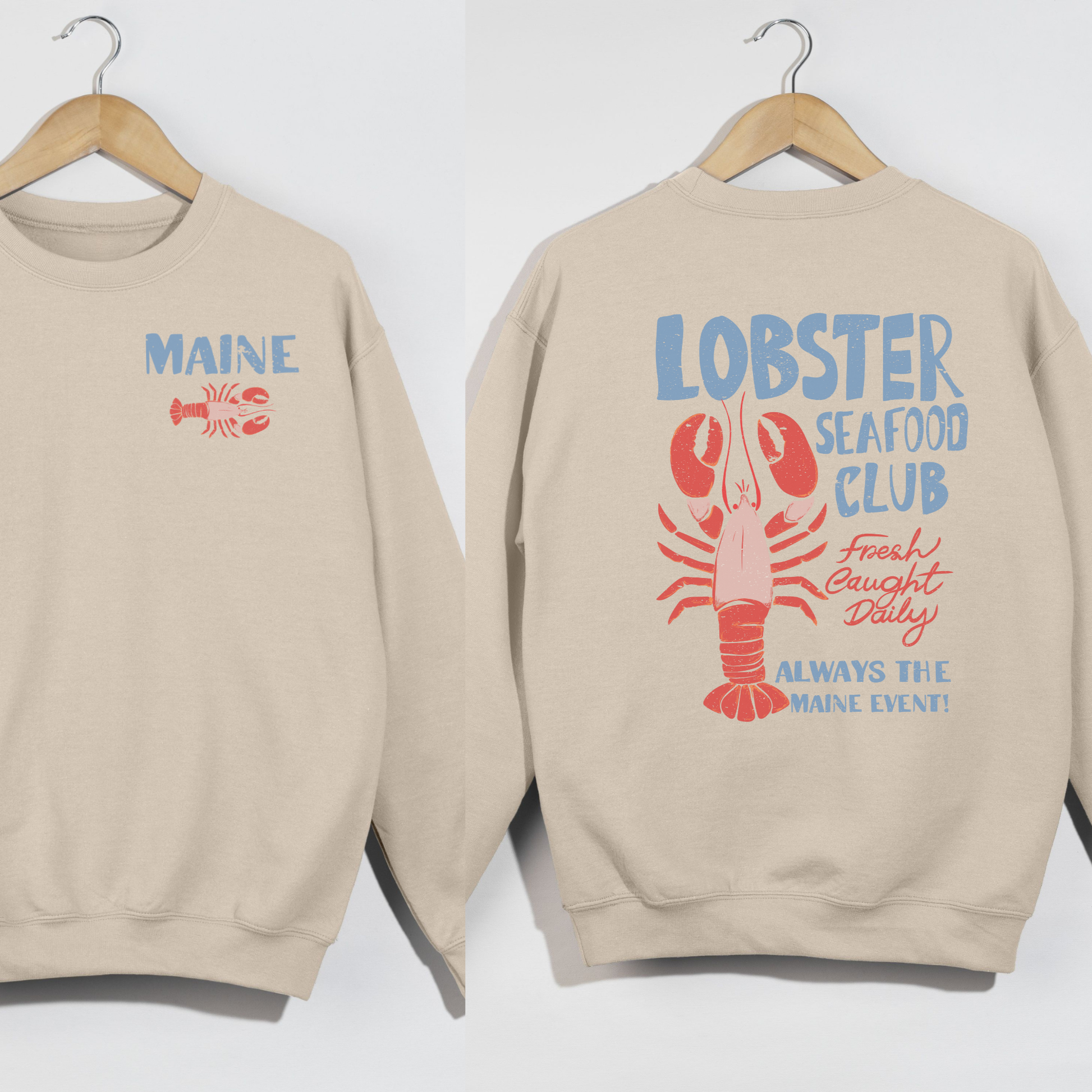 Beige sweatshirt with 'MAINE' and lobster graphic on a white background
