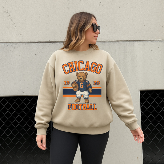 Woman wearing sand Chicago football teddy bear sweatshirt outdoors