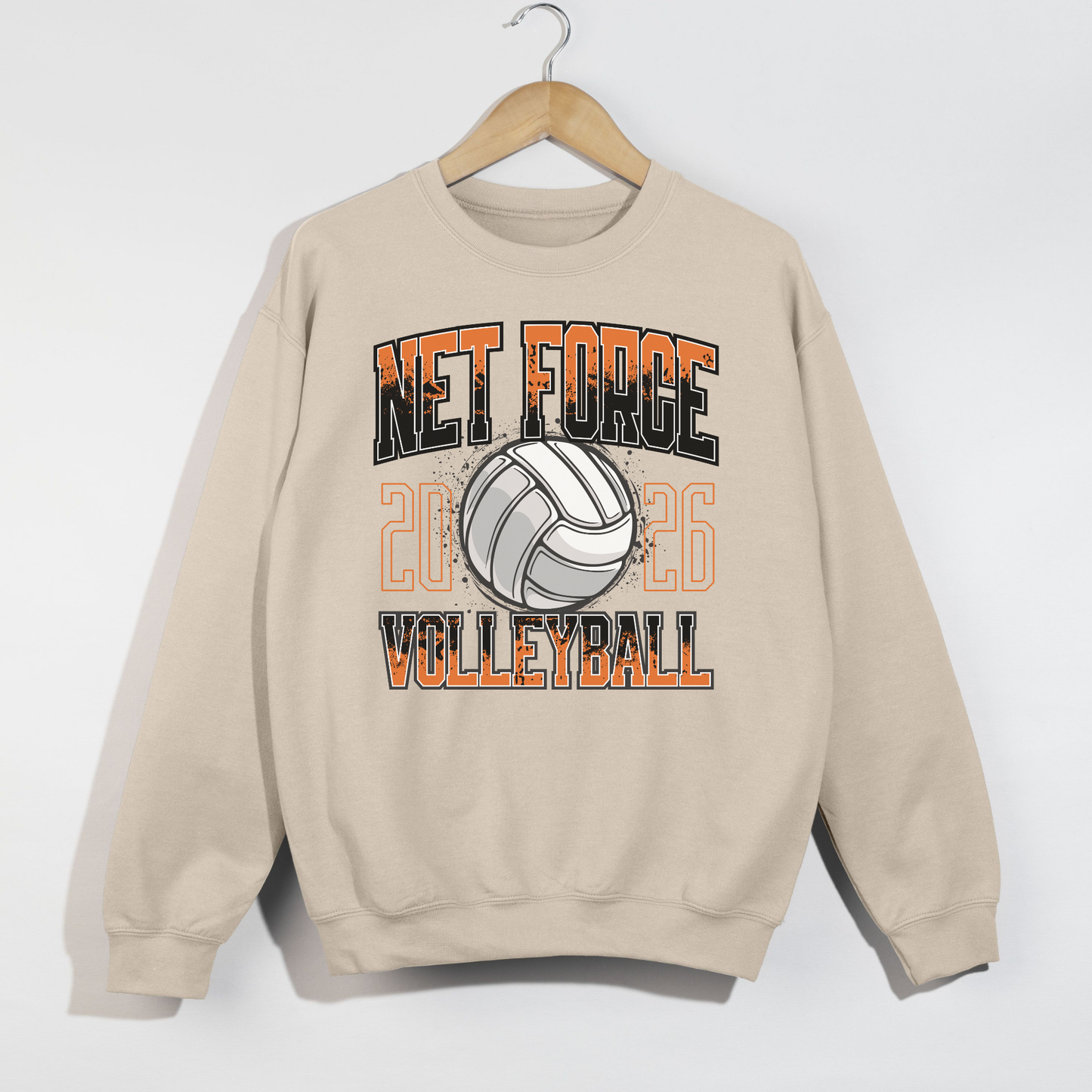 Beige sweatshirt with 'Net Force Volleyball' design on a hanger against a white background