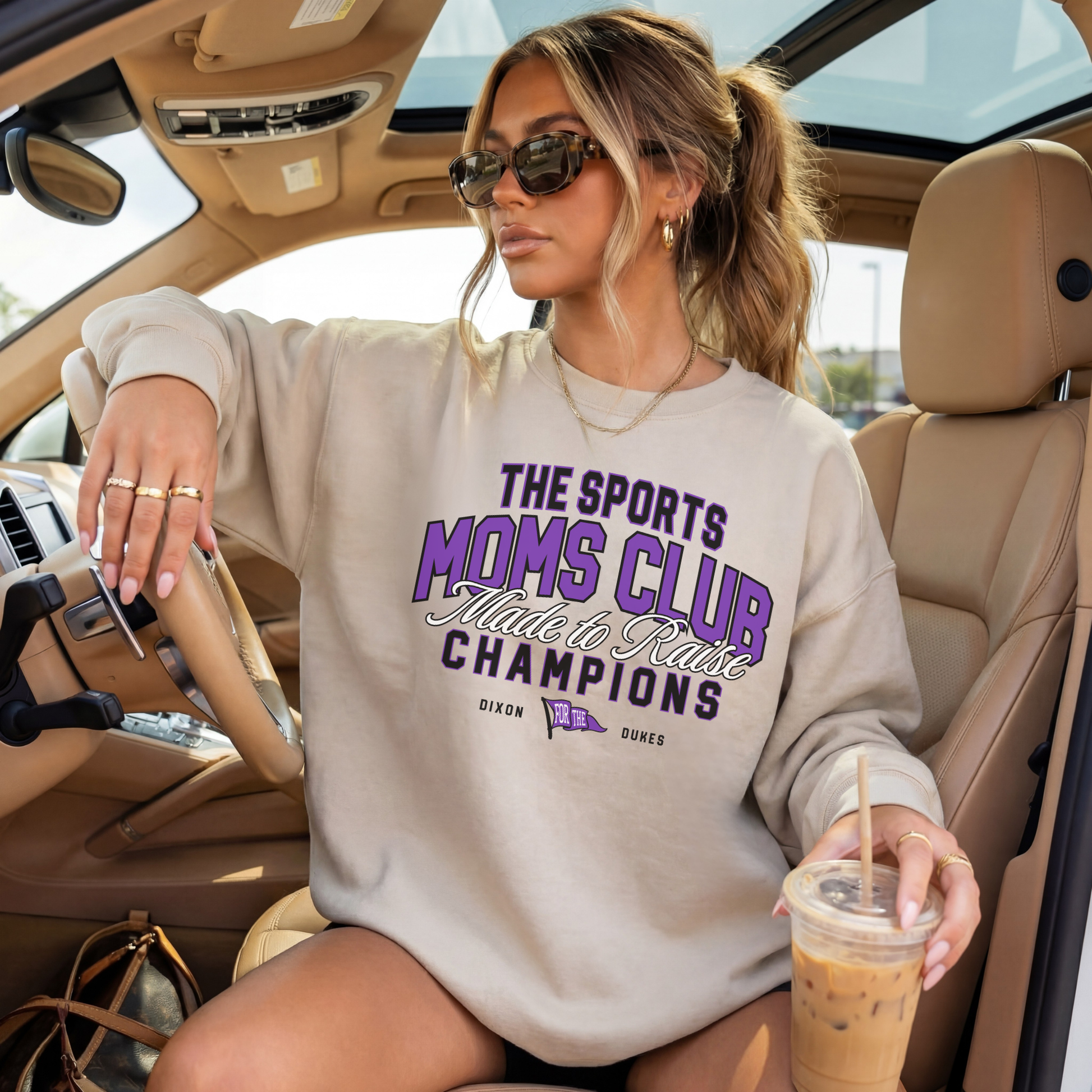 Sand crewneck Sports Moms Club Dixon Dukes sweatshirt styled in car holding iced coffee casual outfit