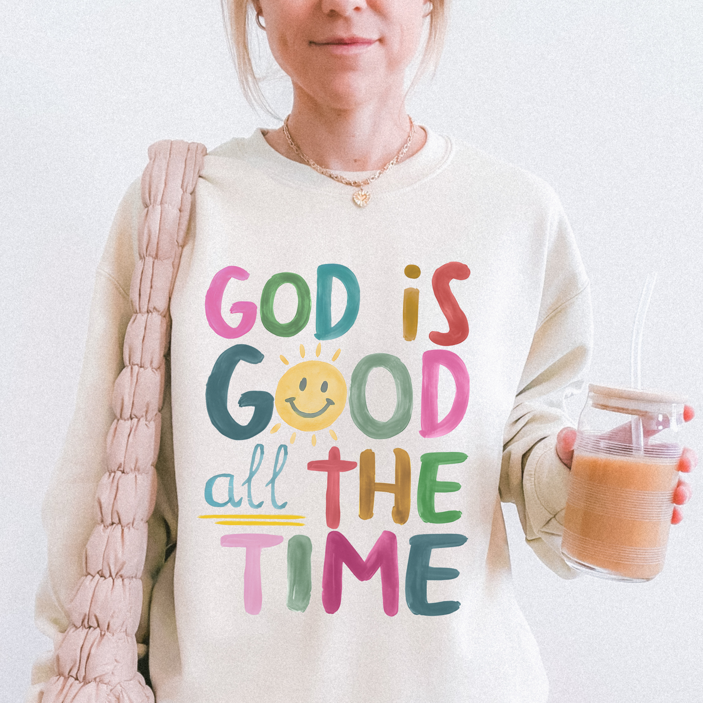 Person wearing a sweatshirt with 'God is Good all the Time' text