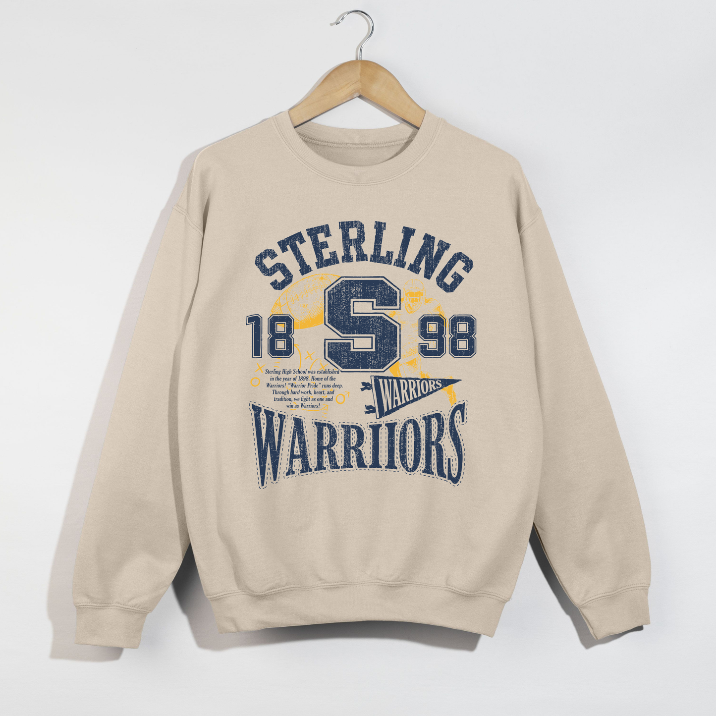 Sand Sterling Warriors football graphic sweatshirt with vintage collegiate artwork in navy and gold.