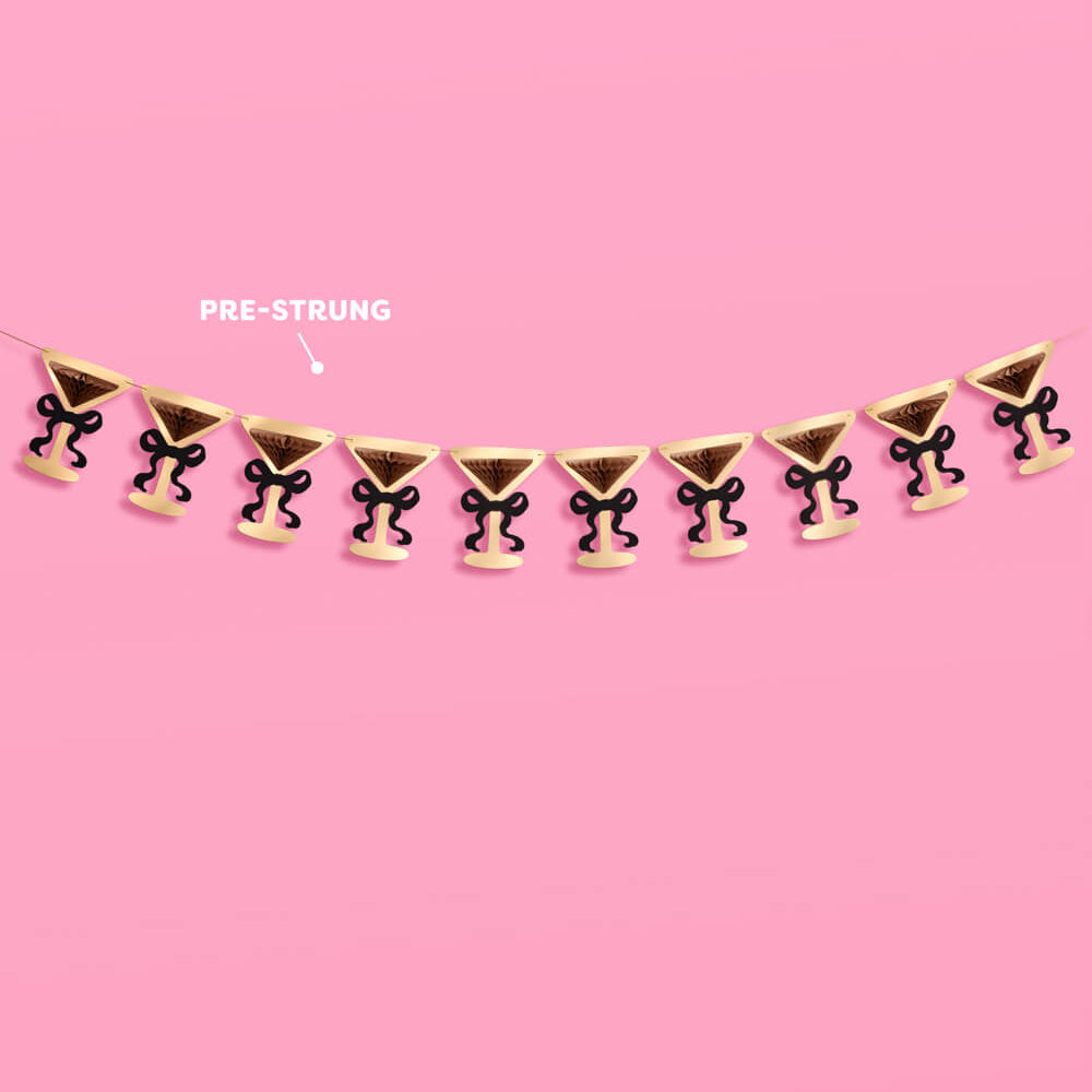 Pre-strung decorative garland with black and gold bows on a pink background