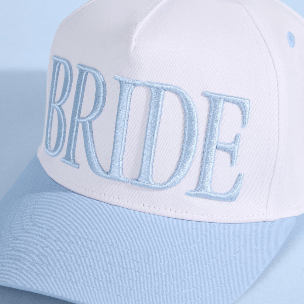 White cap with 'BRIDE' embroidered in light blue on a light blue background