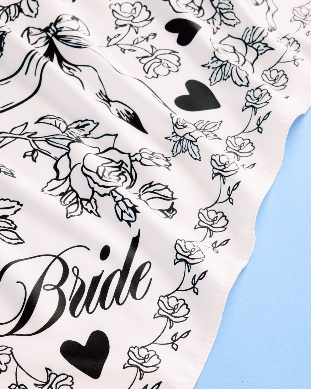 Silk scarf with floral and heart patterns and the word 'Bride' on a white background.