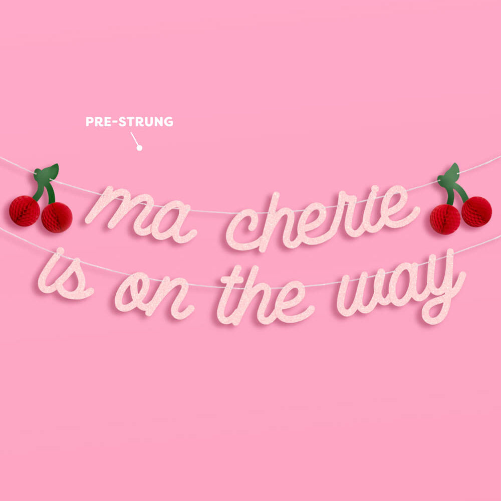 Decorative banner with 'ma chérie is on the way' text and cherry designs on a pink background.