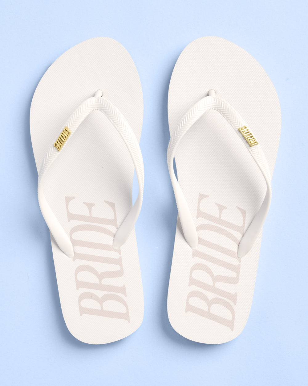 White flip-flops with 'BRIDE' text on a light blue background