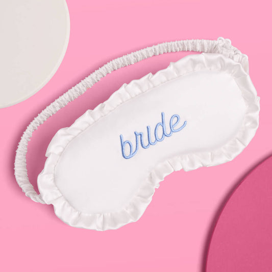 White sleep mask with 'bride' embroidery on a pink background