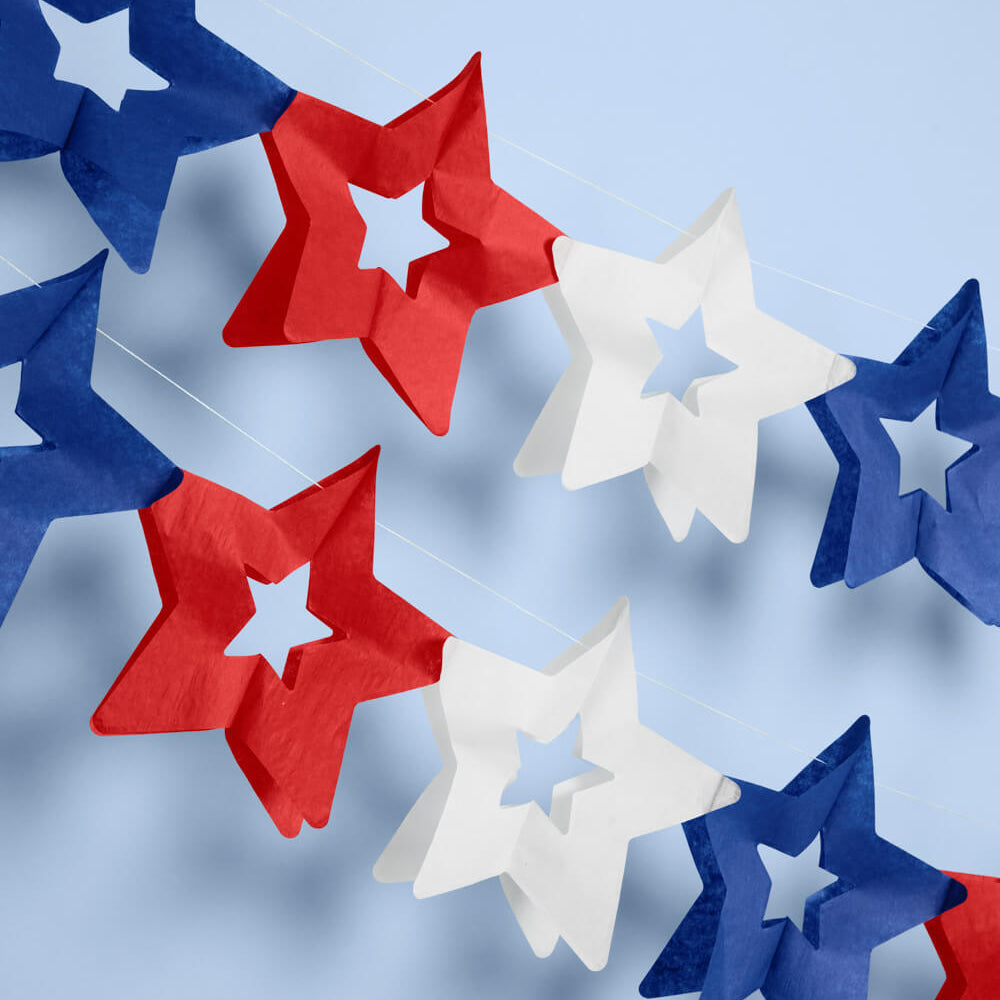 Red, white, and blue star-shaped decorations on a light blue background