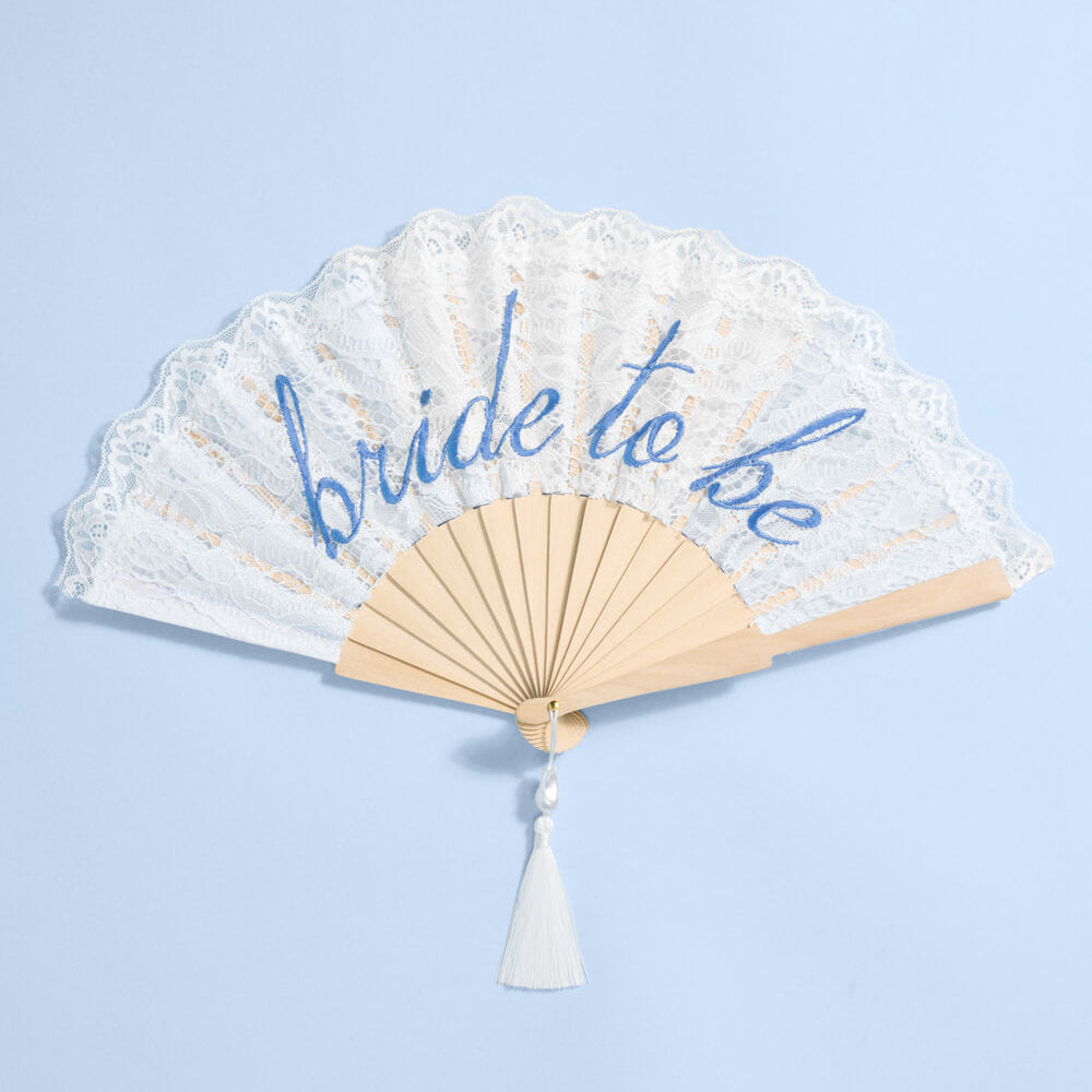 Handheld fan with 'bride to be' text on a light blue background