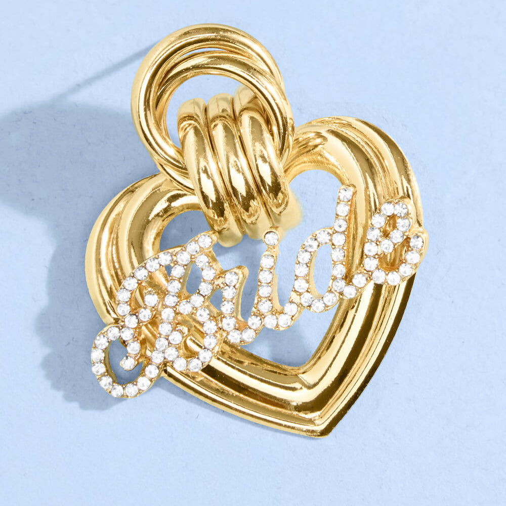 Close up of gold metal heart bridal earrings with crystal rhinestone script