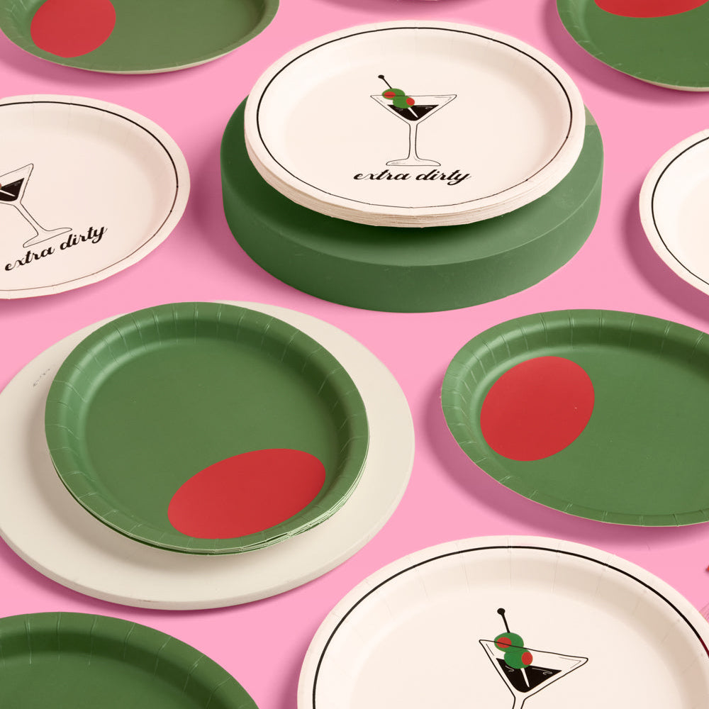 Set of paper plates with green and red designs on a pink background