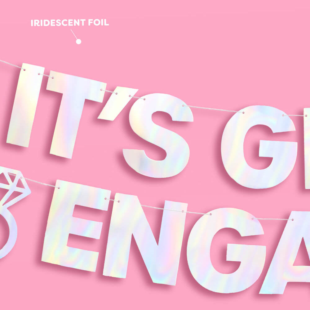 Iridescent 'It's Going to Be Engaged' banner on a pink background