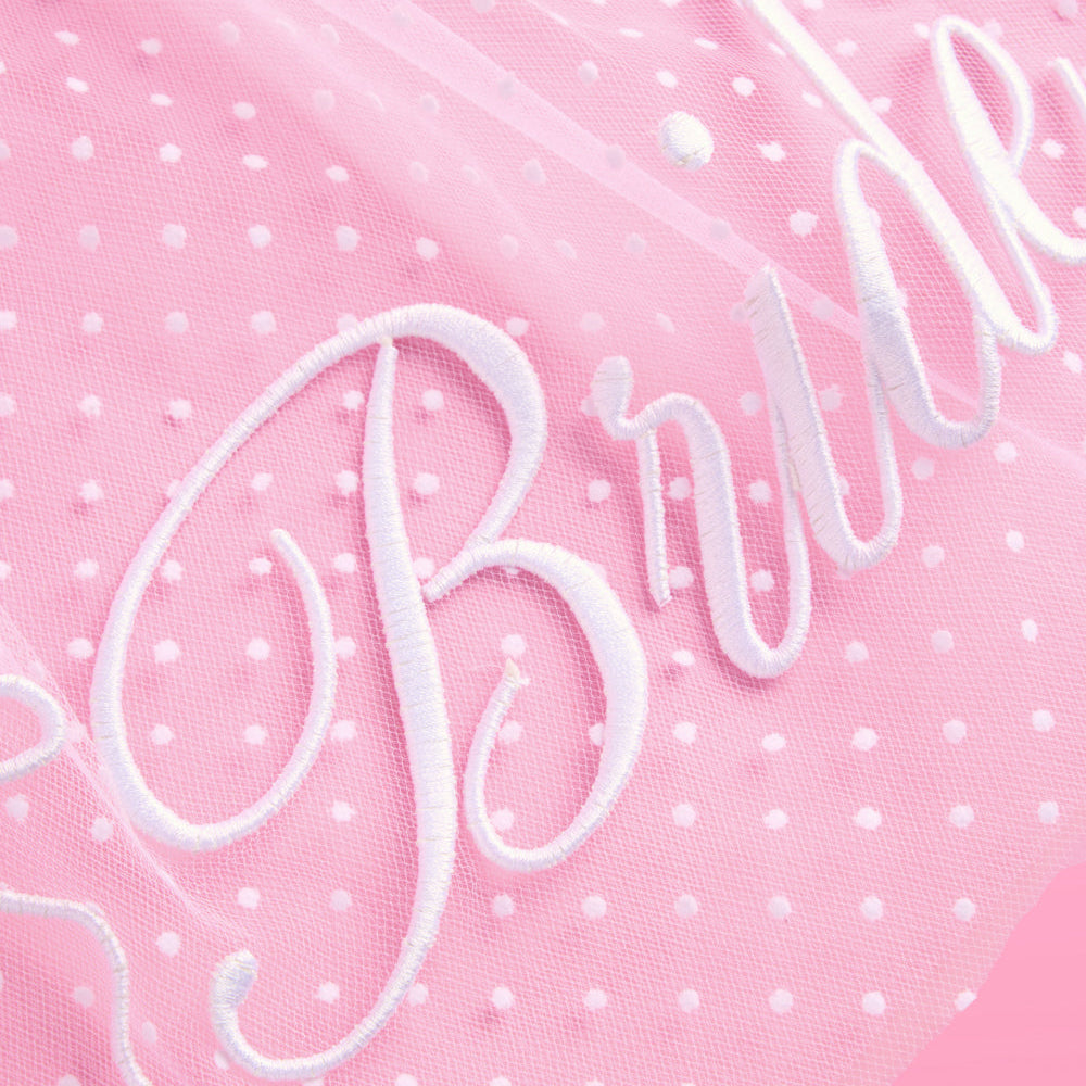 Pink fabric with white polka dots and 'Bride' embroidery