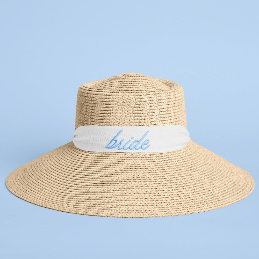 Beige sun hat with a white band and 'bride' embroidery on a light blue background