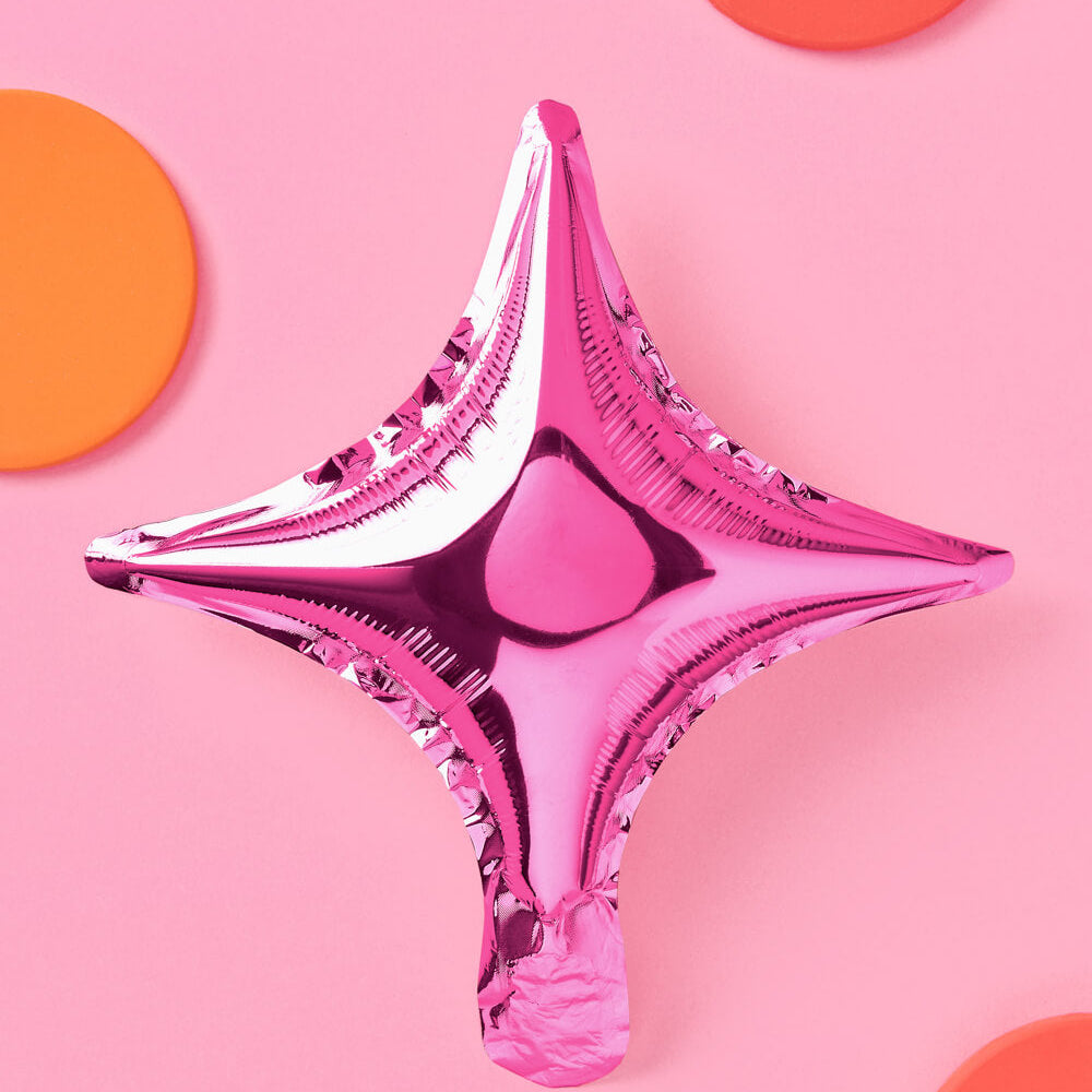 Pink star-shaped balloon on a pink background with orange circles