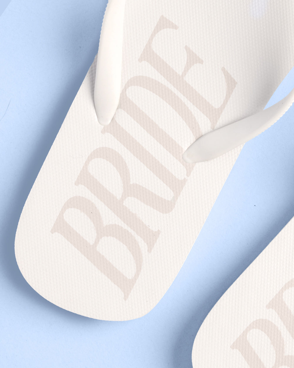 White sandal with bride on a light blue background