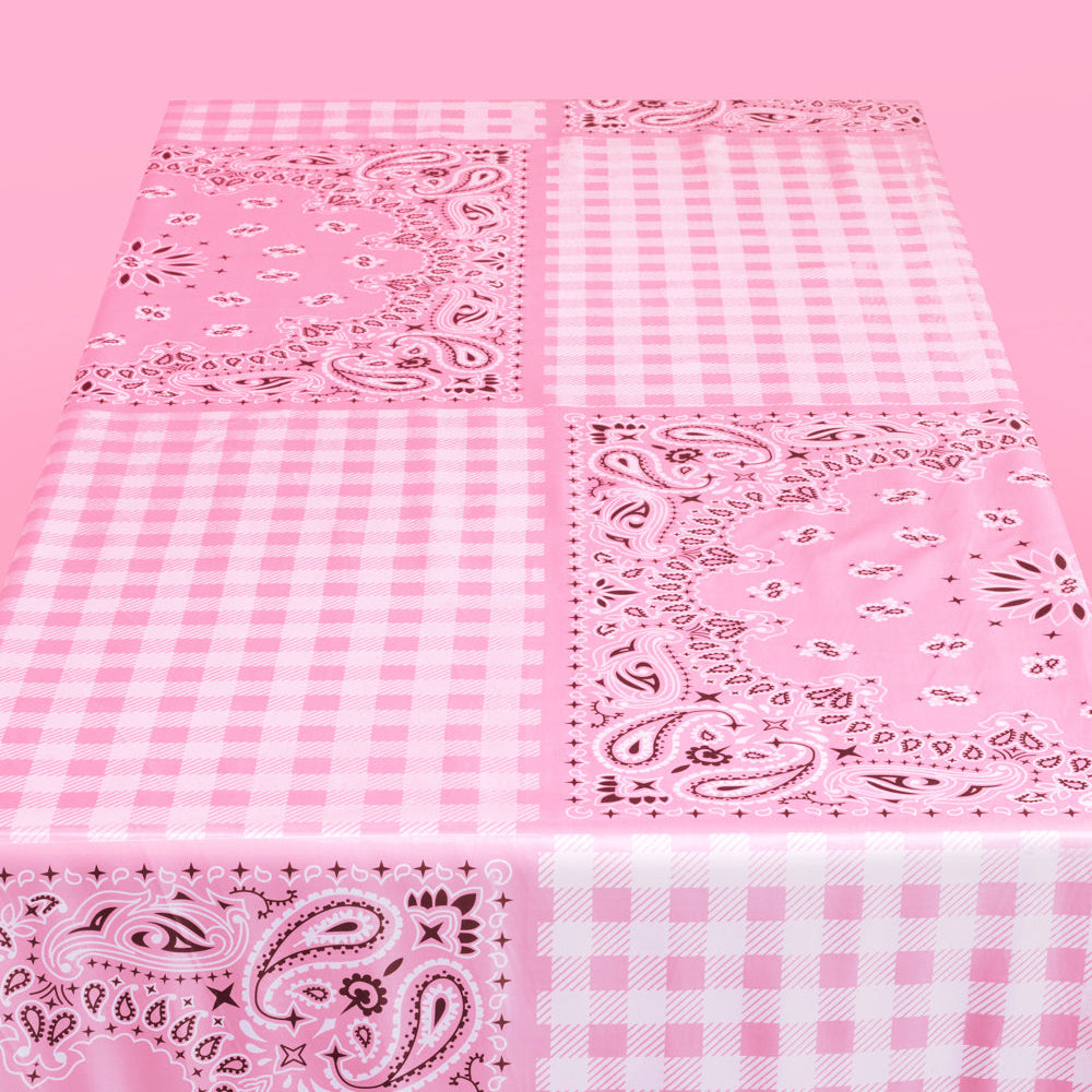 Pink fabric with paisley and check patterns on a pink background