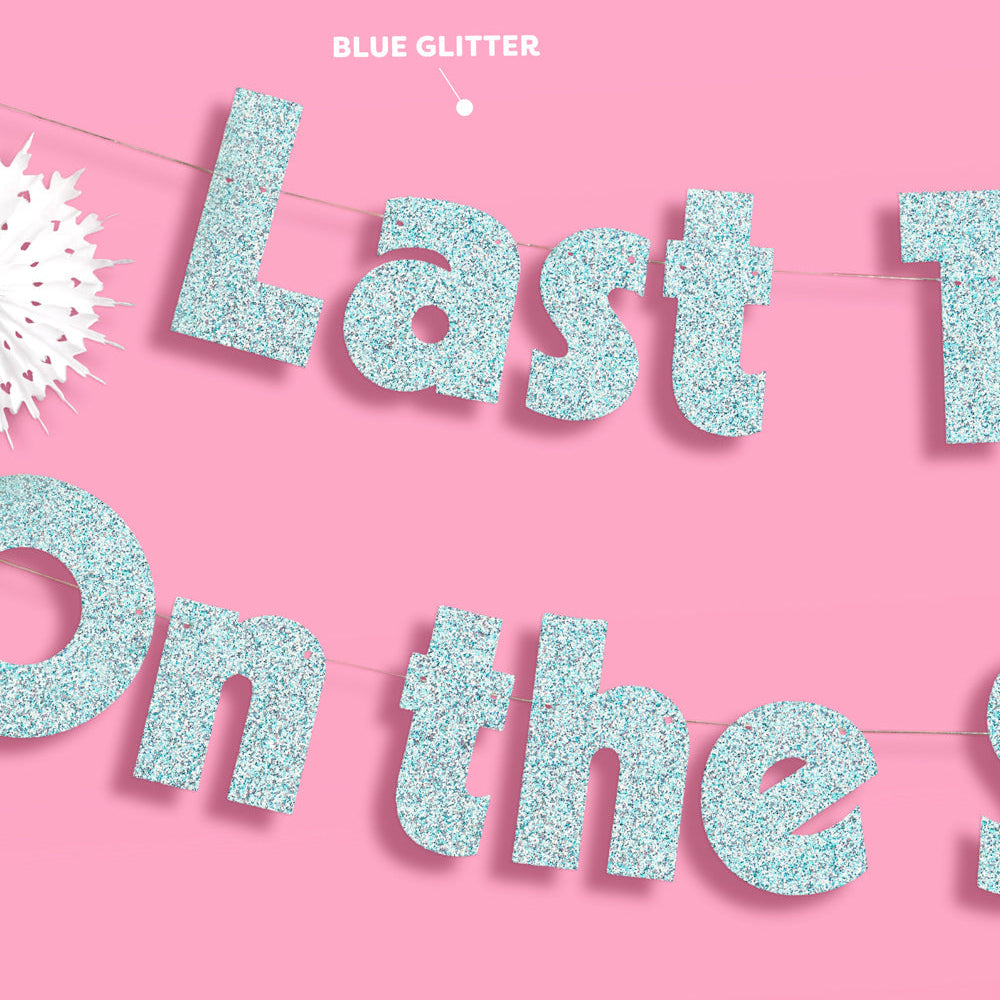 Blue glittery 'Last One On The Left' banner on a pink background