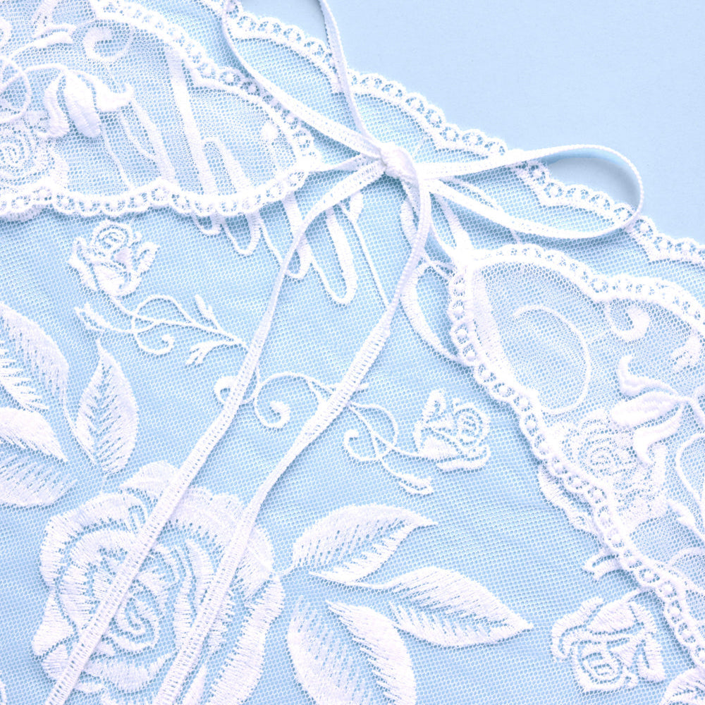 White lace with floral patterns on a light blue background