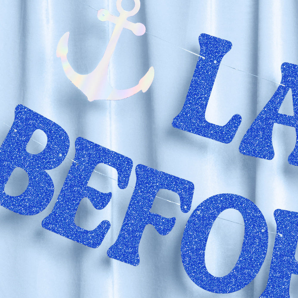 Blue glittery banner with 'LAST BEFORE' text and anchor on a light blue curtain background