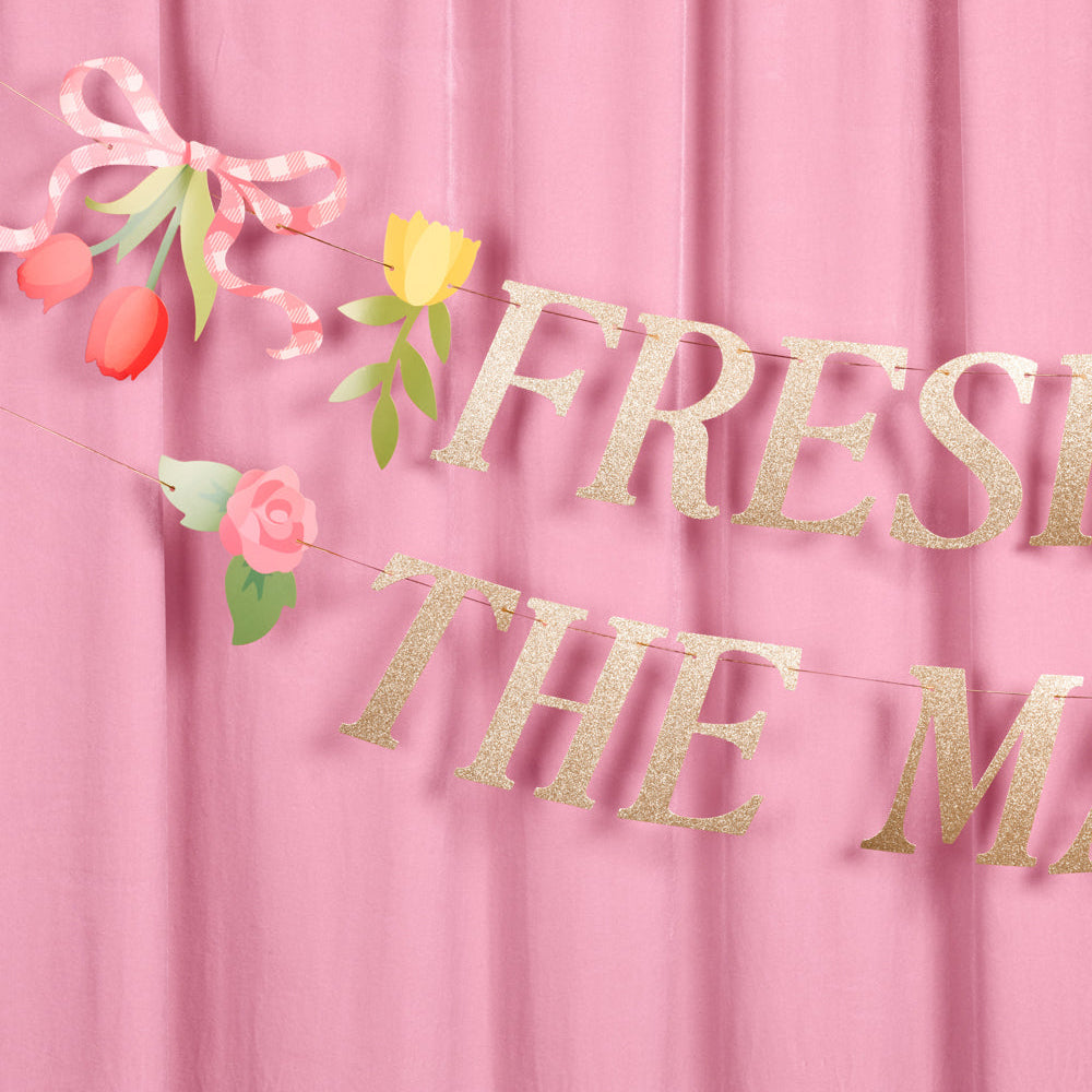 Gold glitter 'Fresh is the new old' banner with flowers on a pink background