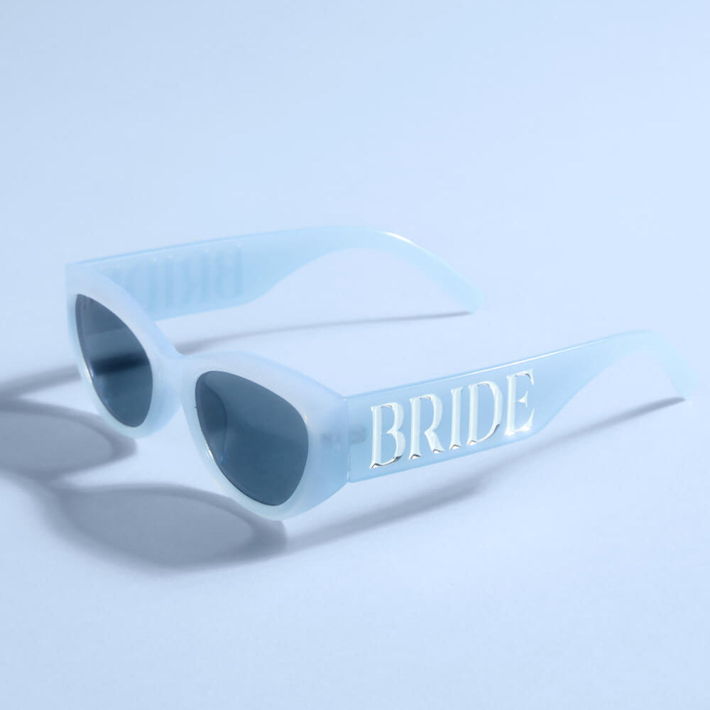 Light blue sunglasses with 'BRIDE' text on a light blue background