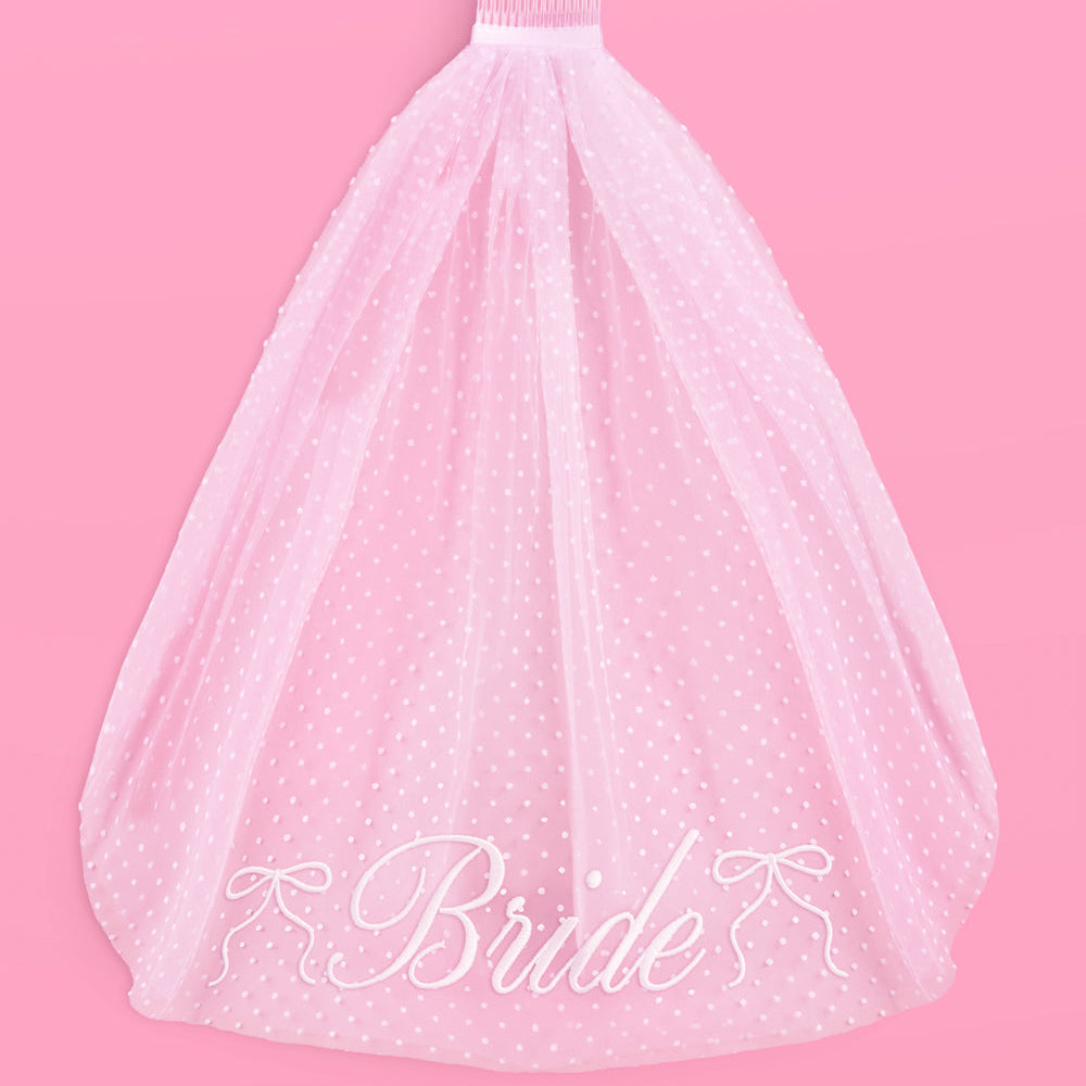 White tulle skirt with 'Bride' embroidery on a pink background