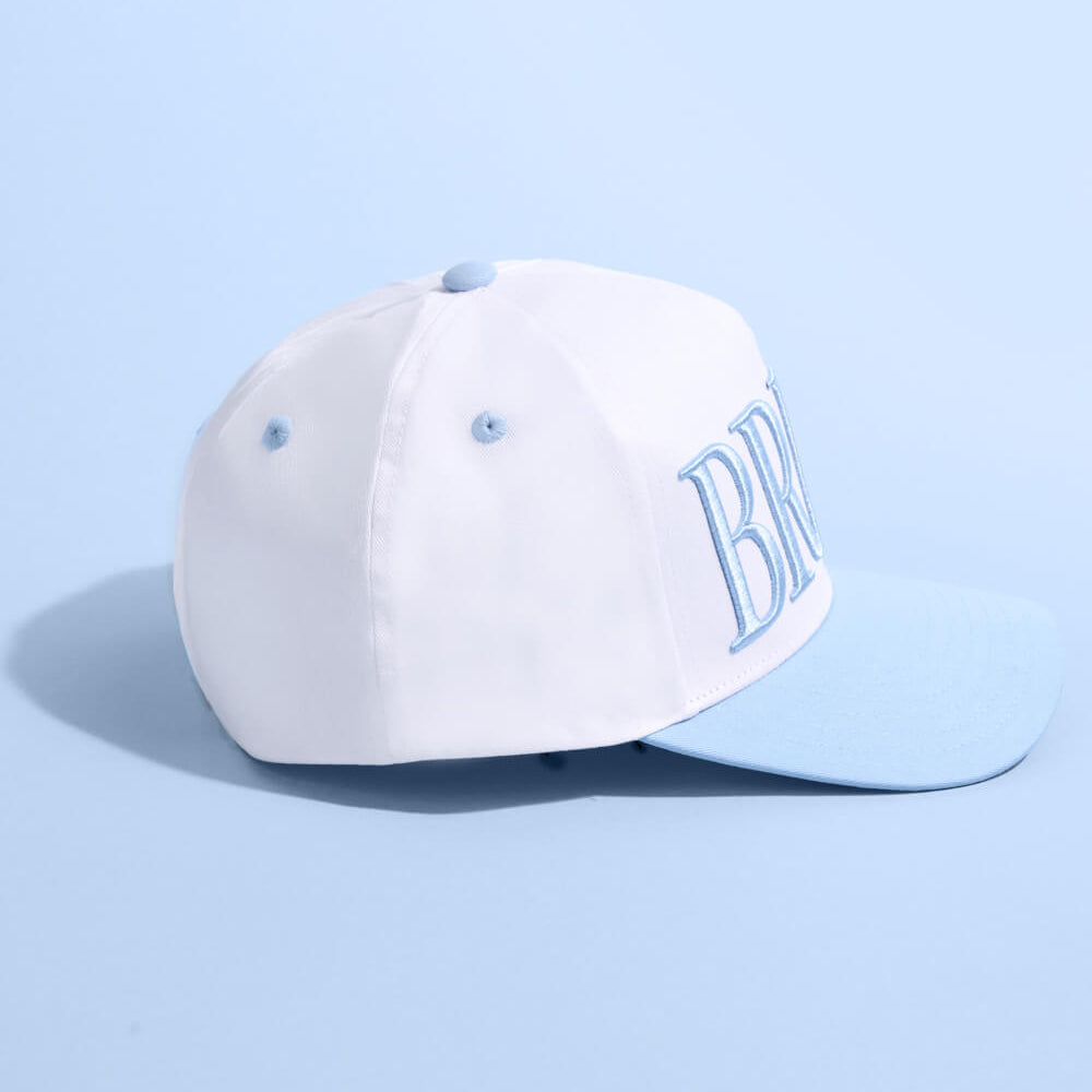 White cap with 'BR' logo on a light blue background