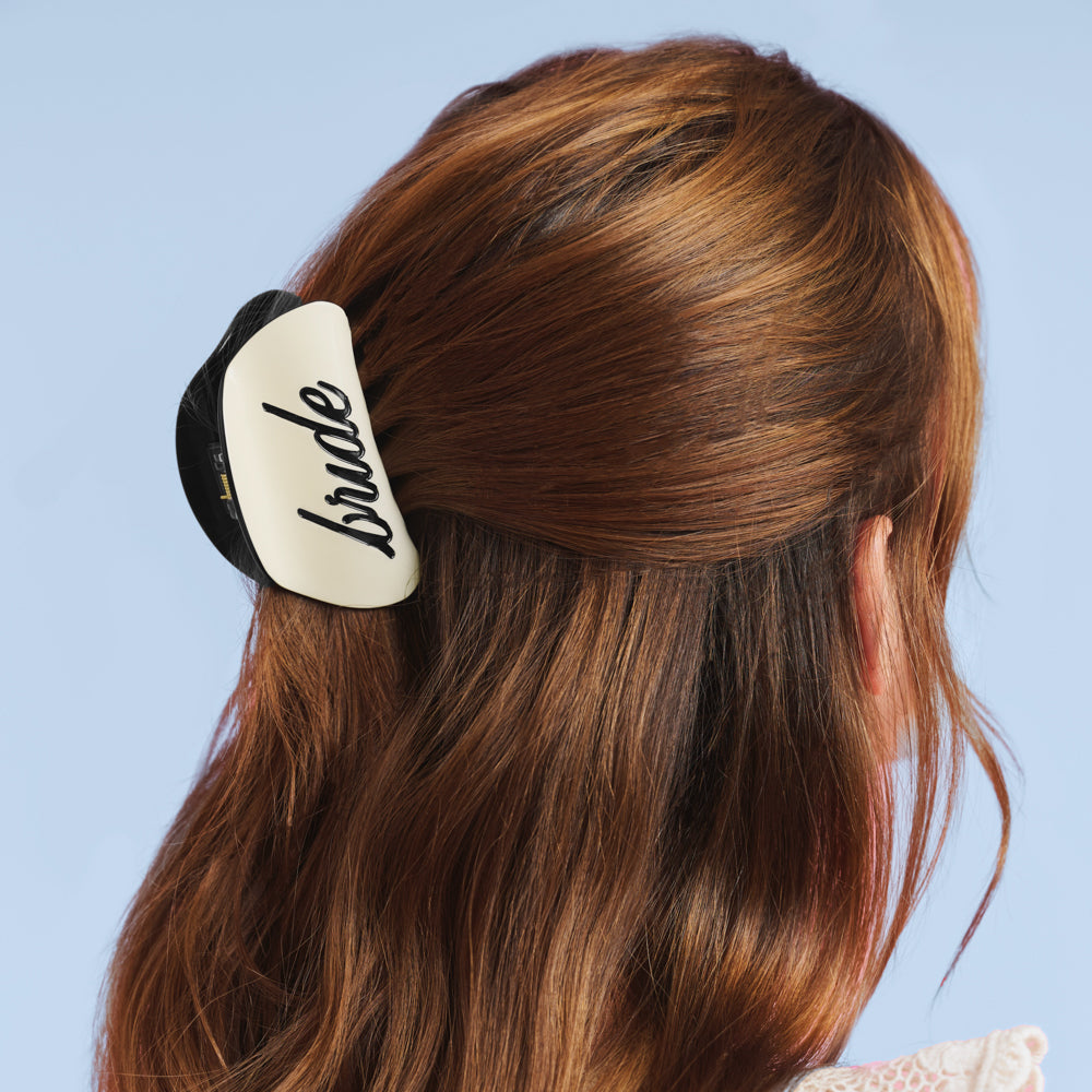 Bride wearing ivory claw clip with black bride logo styled half-up for bridal shower or bachelorette event