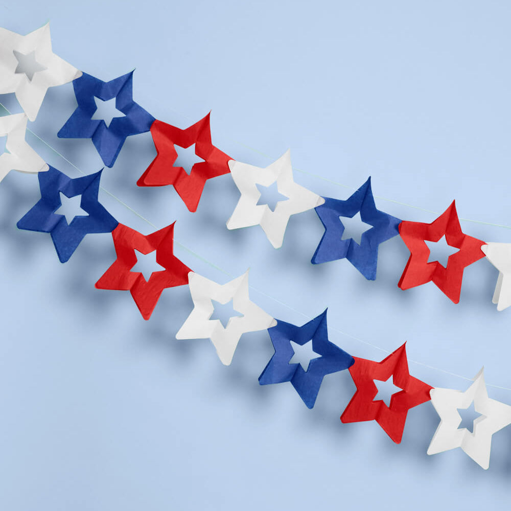 Star-shaped decorations in red, white, and blue on a light blue background