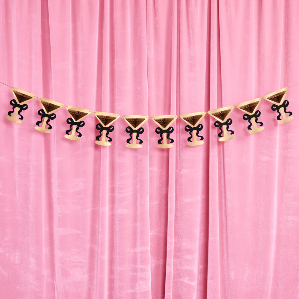 Decorative banner with skull and crossbones design on a pink curtain background