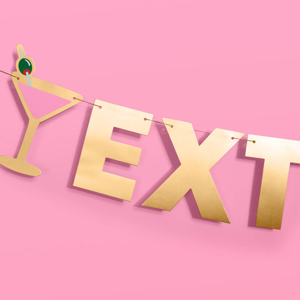 Gold 'EXTRA DIRTY' banner with a martini glass on a pink background