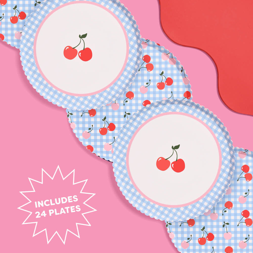 Set of plates with cherry design on a pink background