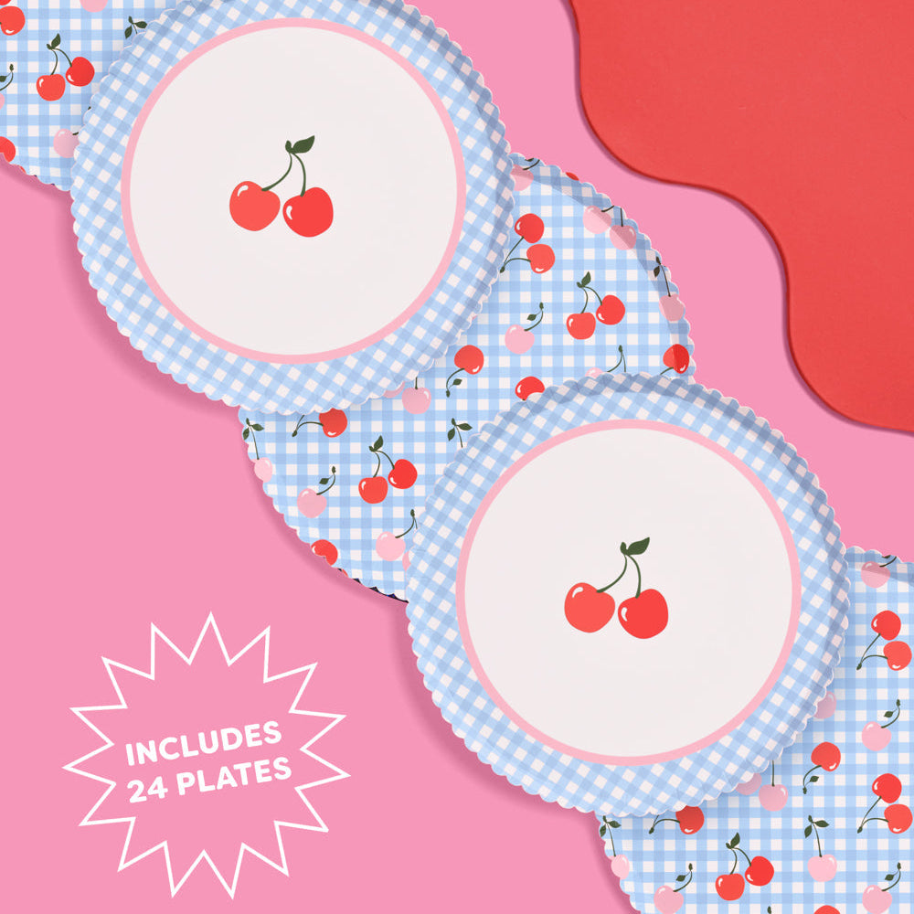 Set of plates with cherry design on a pink background