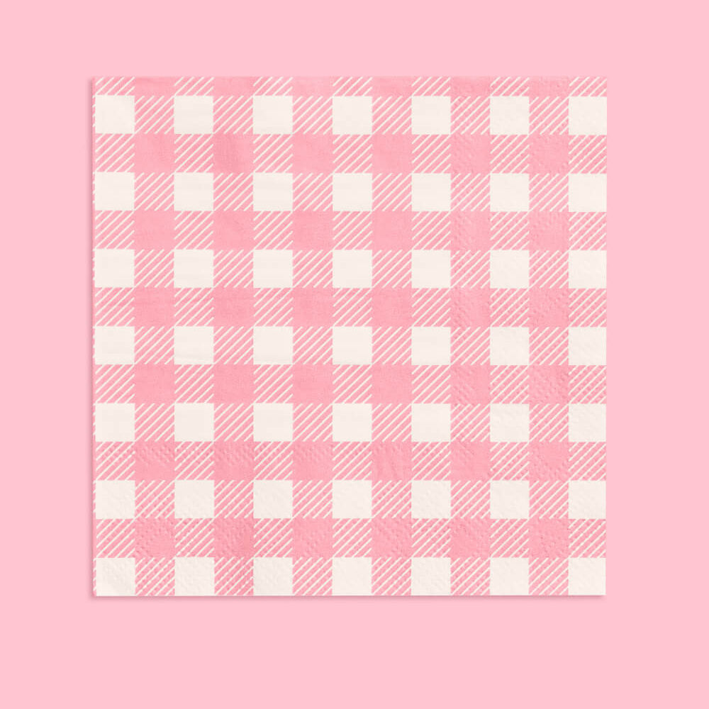 Pink and white checkered pattern napkin on a pink background