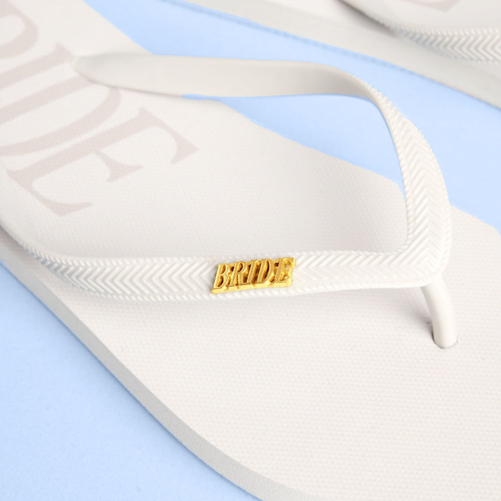 White flip-flop sandal with 'Bride' label on a light blue background
