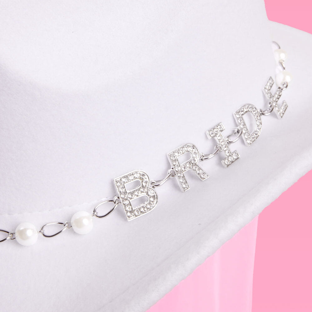 hat with 'BRIDE' and pearl details on a pink and white background