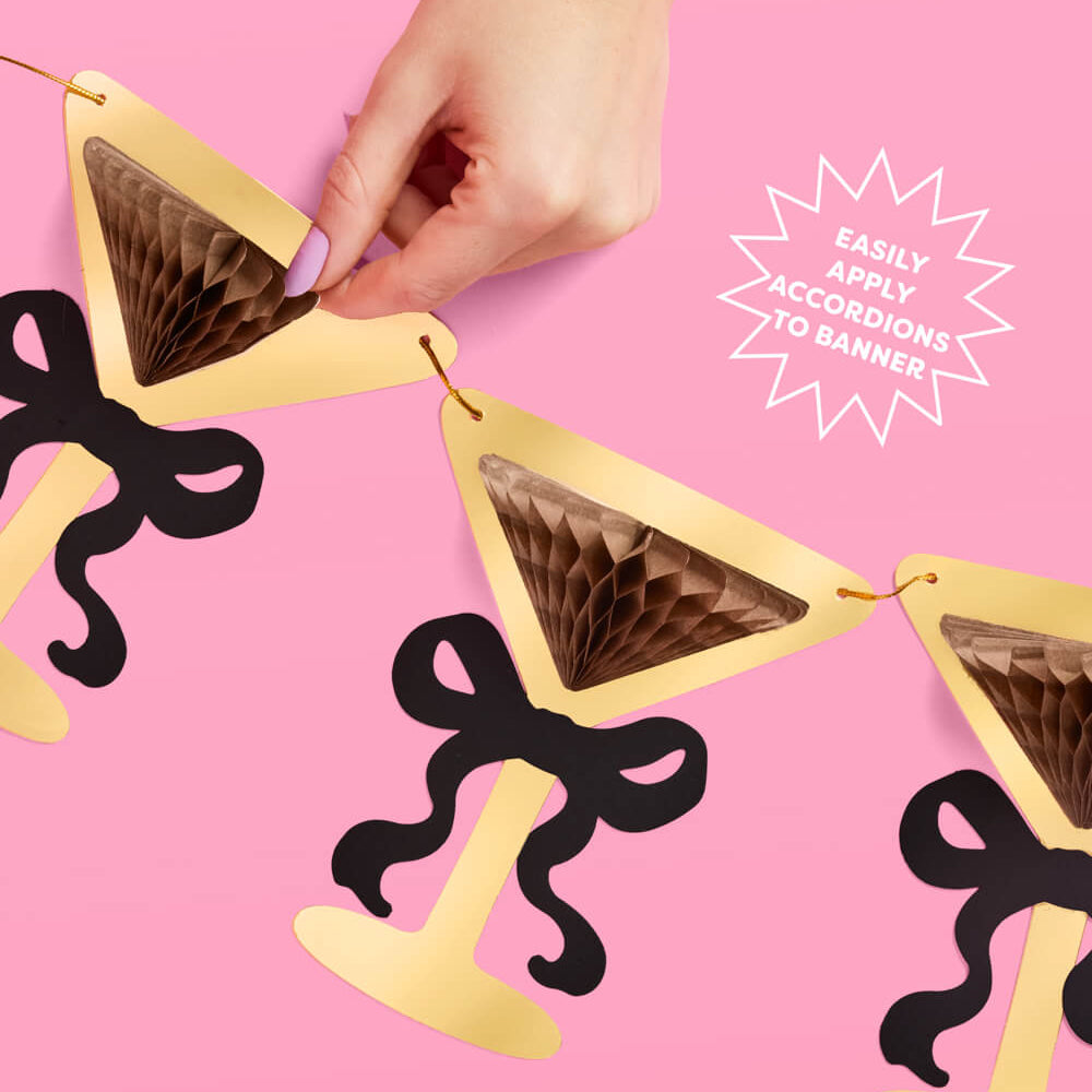 Decorative banner with gold triangles and black bows on a pink background