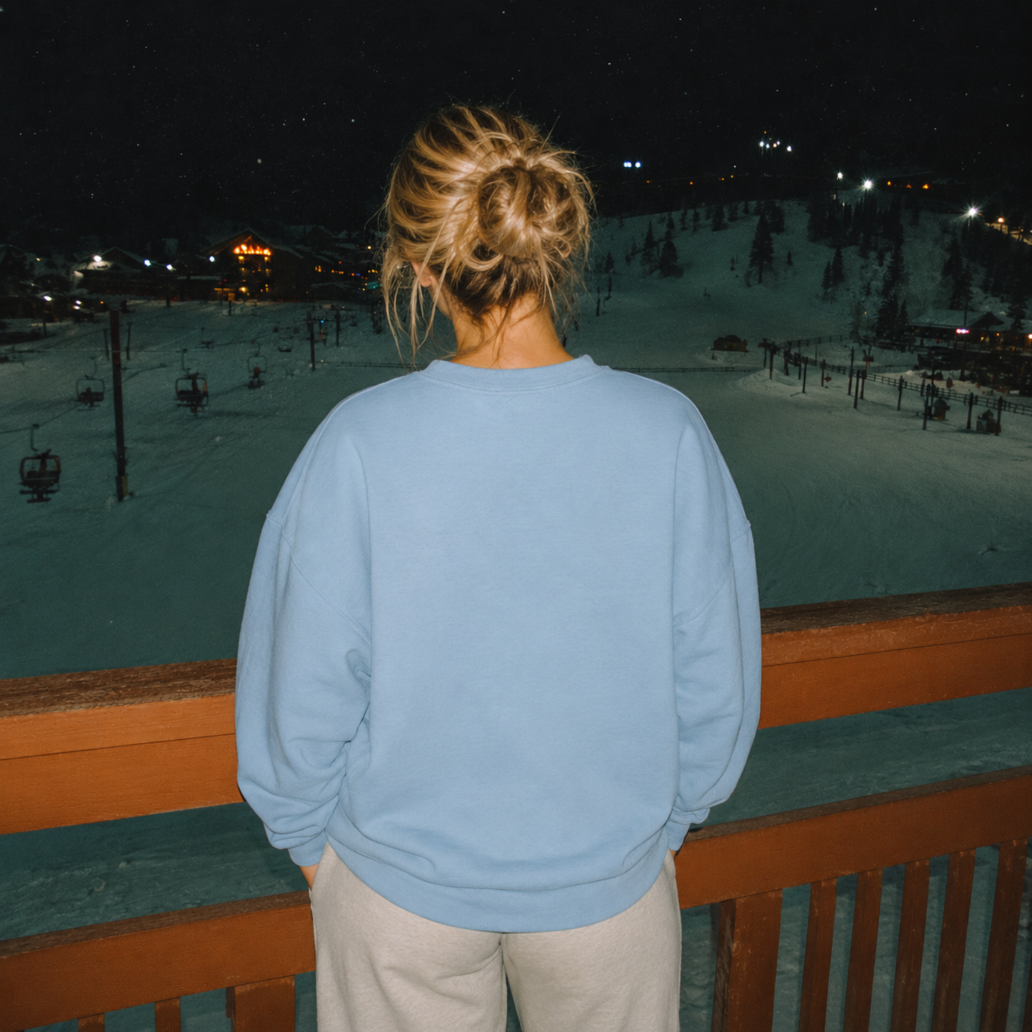 Back view of stone blue crewneck sweatshirt at winter ski resort